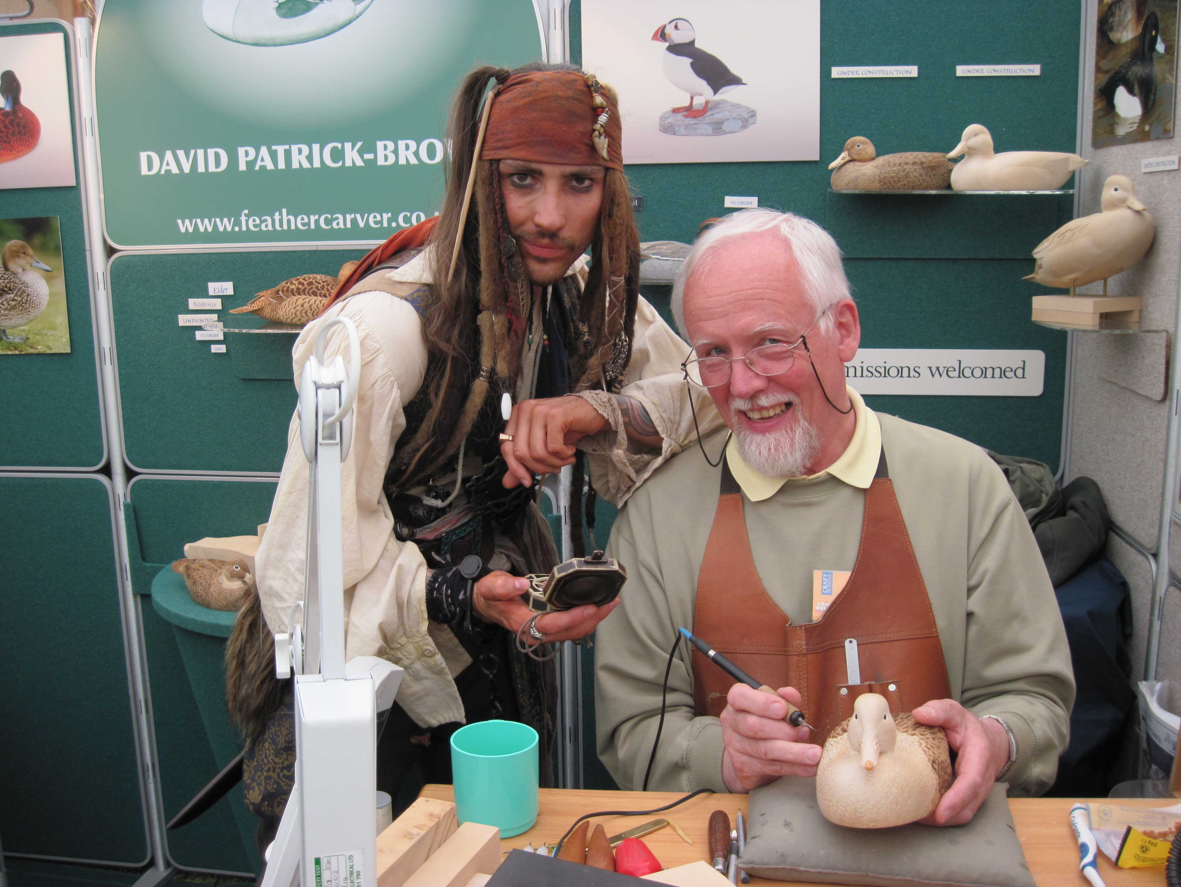 Feathercarver David Patrick-Brown with a visitor on his show stand